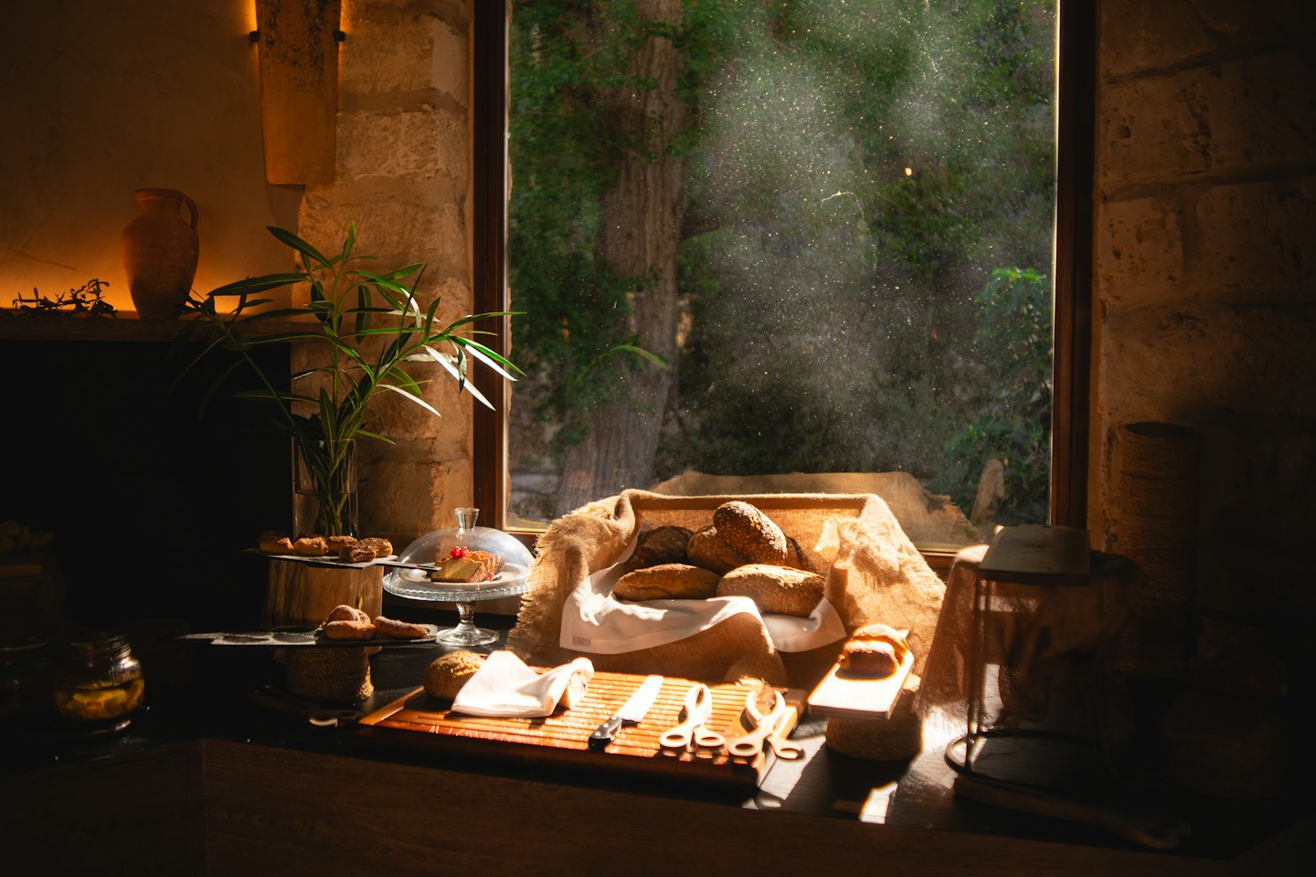 Freshly baked bread and pastries arranged on a wooden counter.